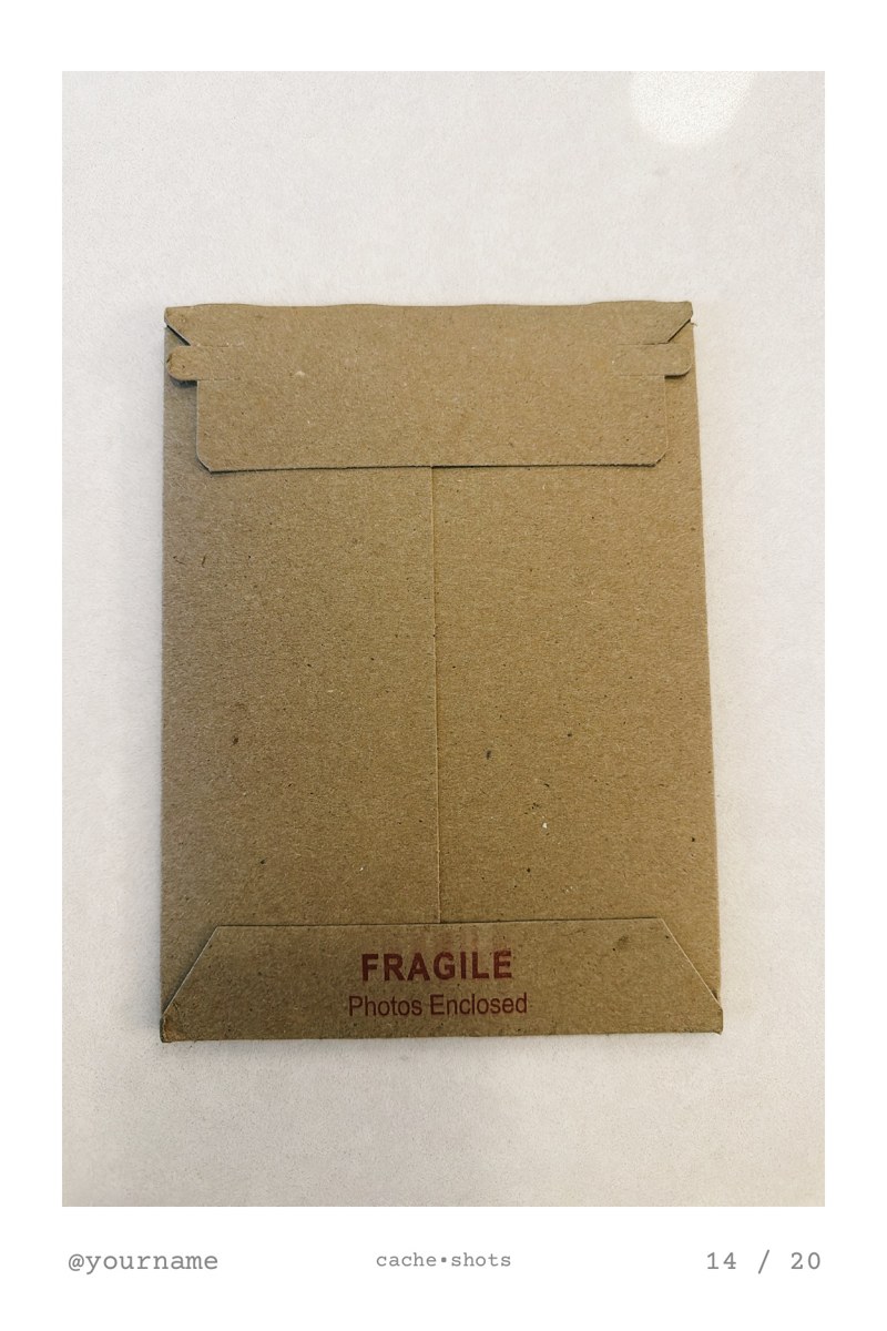 a 4x6 print of the kraft mailer the prints arrive in, stamped fragile, photos enclosed, with @yourname and 14 / 20 along the bottom
